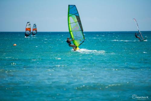 a group of people windsurfing in the ocean at Oasis Apartments in Kalliópi