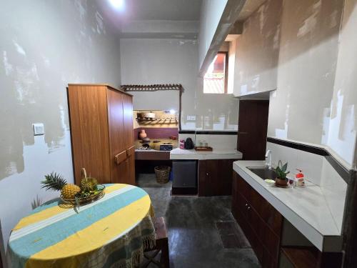 a large kitchen with a table and a sink at Dorala Villa-Your home away home in Kuruwita