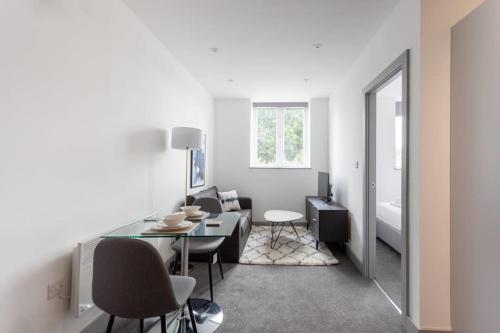 a white living room with a table and chairs at Contemporary 1 Bedroom Apartment Leeds in Leeds