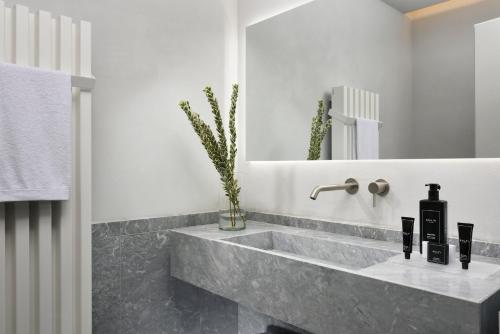 a bathroom with a sink and a mirror at The Bank Hotel - Locanda della Posta Dependance in Perugia