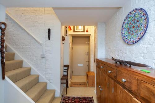 a staircase in a home with a stair case at Charming 1 Bedroom Apartment in old School House in London