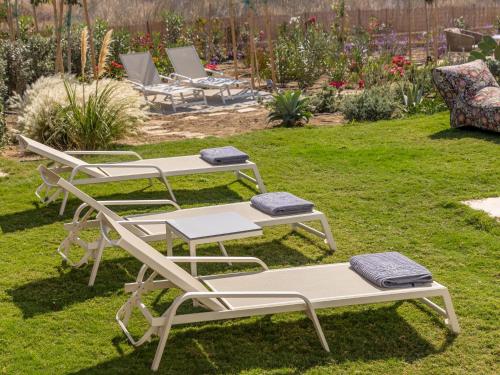 three picnic tables and chairs in a yard at Plioni Villas With Private Pool & Suites With Hot Tub in Mikri Vigla