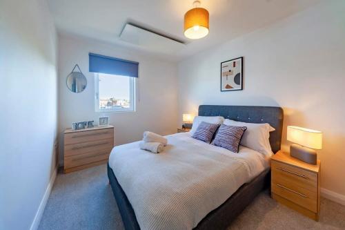 a bedroom with a large bed and two night stands at Modern 1 Bedroom Apartment in Ashford in Ashford