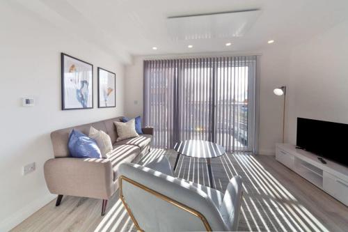 a living room with a couch and a television at Modern 2 Bedroom Apartment in Ashford in Ashford