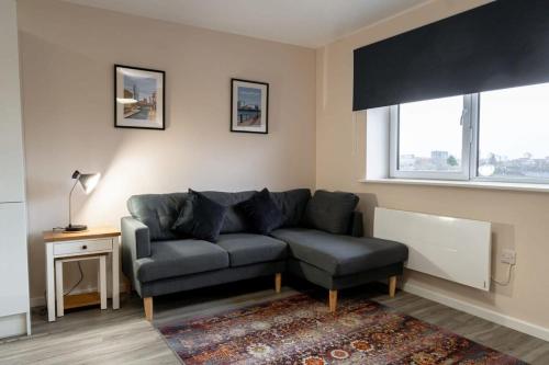a living room with a couch and a chair at Modern 1 Bedroom Apartment in Manchester in Manchester