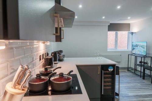 a kitchen with two pots on top of a stove at Lovely 1 Bedroom Apartment in Preston in Preston