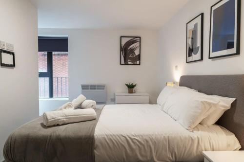 een slaapkamer met een groot bed met witte lakens bij Lovely 1 Bed Apartment in Liverpool Centre in Liverpool