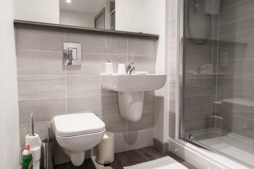 a bathroom with a toilet and a sink and a shower at Lovely 1 Bed Apartment in Liverpool Centre in Liverpool