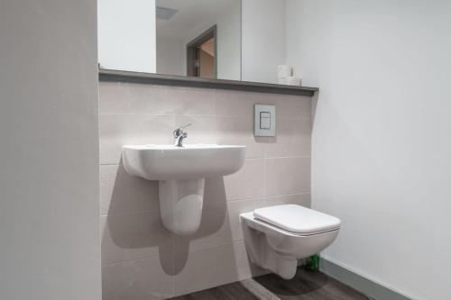 a bathroom with a sink and a toilet at Modern 1 Bed Apartment in Liverpool Centre in Liverpool
