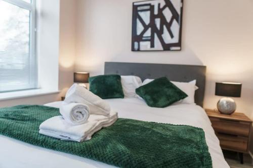 a bed with green and white towels on it at Fantastic 1 Bed Apartment Manchester - Sleeps 2 in Manchester