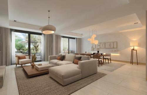 a living room with a couch and a dining room at Ruins Luxury Resort - Adults Only in Yalıkavak