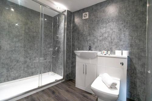 y baño con aseo, lavabo y ducha. en Modern 2 Bedroom Apartment in Sunderland, en Sunderland