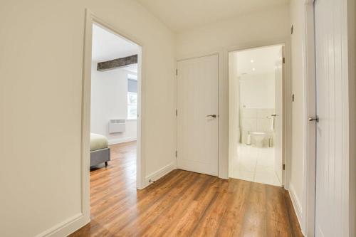 a white room with a mirror and a bathroom at Modern 2 Bedroom Apartment in Burnley in Burnley