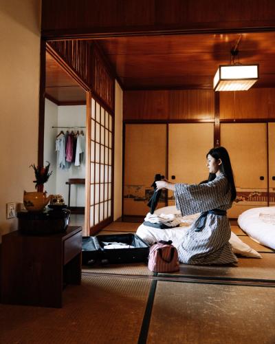 a woman in a kimono in a room at Hokke Lumbini in Lumbini
