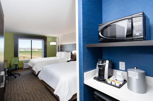 a hotel room with two beds and a tv at Holiday Inn Express Hotel & Suites Yuma by IHG in Yuma