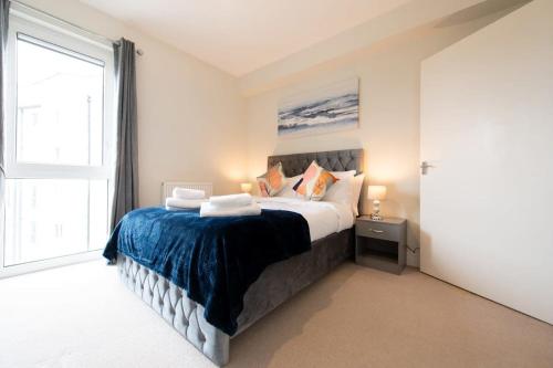 a bedroom with a bed and a large window at Fantastic 1 Bed Apartment in Crawley in Crawley