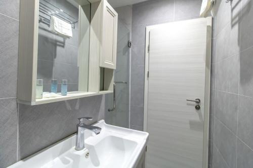 a white bathroom with a sink and a shower at Lovely Central Sunderland Budget Studio in Sunderland