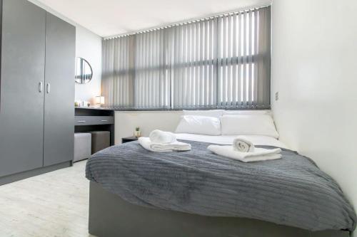 a bedroom with a bed with two towels on it at Lovely Central Sunderland Budget Studio in Sunderland