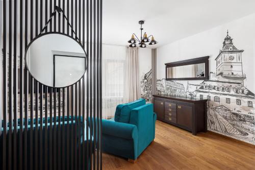 a living room with a blue chair and a mirror at PEAK Aparthotel - Old Town - by CityHost in Braşov