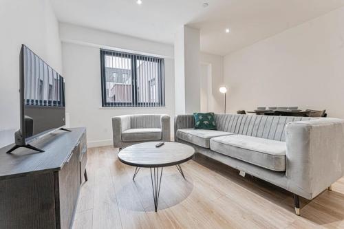 a living room with a couch and a table at Modern and Bright 2 Bed Apartment in Solihull in Birmingham