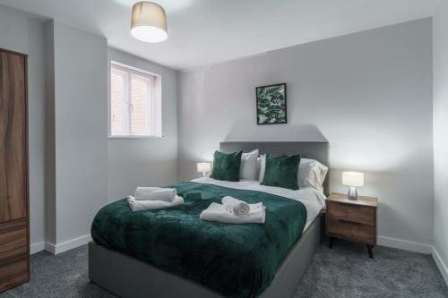 a bedroom with a bed with towels on it at Modern 2 Bedroom Apartment in Liverpool in Liverpool