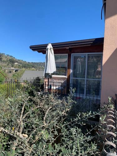 an umbrella sitting outside of a house at Villa Clementine in Piazza Armerina
