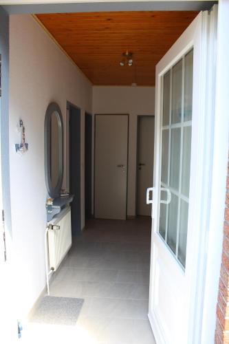 an open door to a hallway with a mirror at Ferienhaus Gomann in Dornum