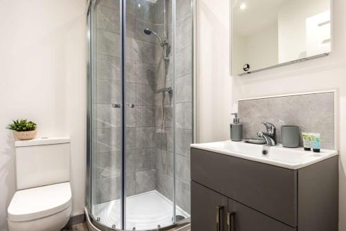 a bathroom with a shower and a sink and a toilet at Modern Budget Apartment in Central Doncaster in Doncaster