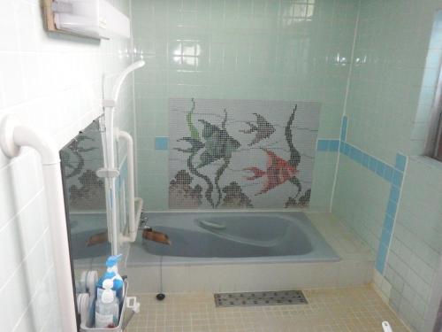 a blue tub in a bathroom with a tile floor at Kajikaen - Vacation STAY 57948v in Kawazu