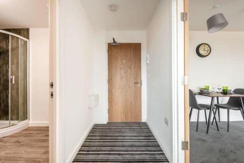 a hallway with a wooden door and a table at Stylish 1 Bed Apartment in Central Retford in Retford