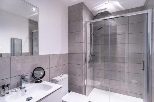 a bathroom with a shower and a toilet and a sink at Modern Studio Apartment near Old Trafford in Manchester