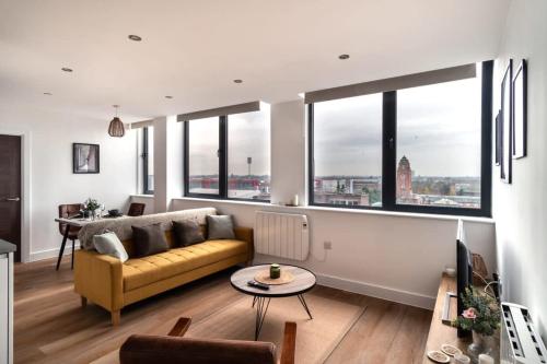 a living room with a couch and some windows at StayZeni, Alexandra Rise Manchester Super 1 Bed in Manchester