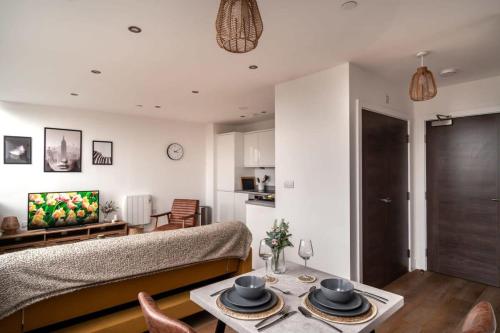 a living room with a couch and a table at StayZeni, Alexandra Rise Manchester Super 1 Bed in Manchester