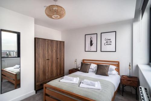 a bedroom with a bed with two towels on it at StayZeni, Alexandra Rise Manchester Super 1 Bed in Manchester