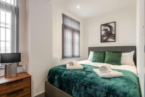 a bedroom with a bed with towels on it at Smart 1 Bed Budget Apartment in Central Doncaster in Doncaster