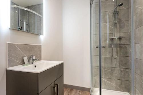a bathroom with a sink and a shower at Smart 1 Bed Budget Apartment in Central Doncaster in Doncaster