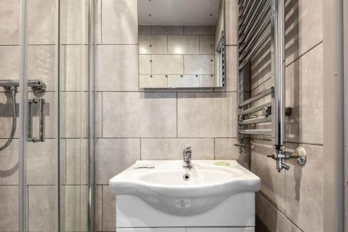 a bathroom with a white sink and a mirror at Contemporary 1 Bed Budget Flat in Central Halifax in Halifax