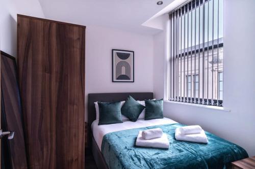 a bedroom with a bed with two towels on it at 1 Bed Apartment in Central Liverpool w Balcony in Liverpool