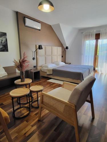 a bedroom with two beds and two tables and chairs at House Tina in Grabovac