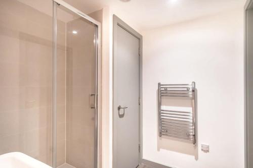 a shower with a glass door in a bathroom at Smart 1 Bedroom Apartment in Liverpool Centre in Liverpool