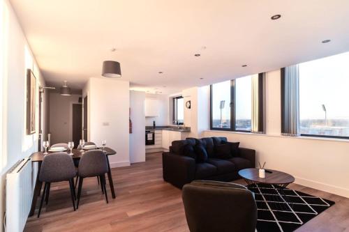 a living room with a couch and a table at StayZeni, Alexandra Rise Manchester 2 Bed Flat in Manchester