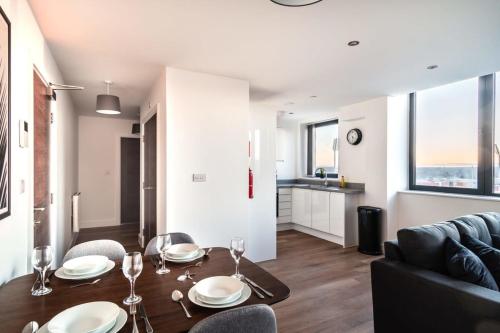 a living room with a table and a couch at StayZeni, Alexandra Rise Manchester 2 Bed Flat in Manchester