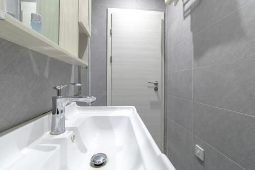 a bathroom with a white sink and a shower at Cosy Budget Sunderland Studio with Great Views in Sunderland