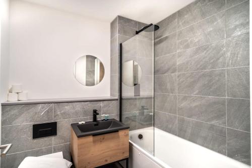 a bathroom with a sink and a bath tub at Stunning 2 Bedroom Apartment in Central Preston in Preston
