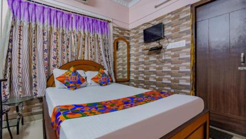 a bedroom with two beds and a television in it at Goroomgo Elite Stay Salt Lake Kolkata Near Metro Station in Kolkata