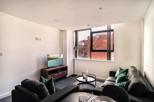 a living room with a couch and a tv at Contemporary 1 Bed Apartment in Central Preston in Preston