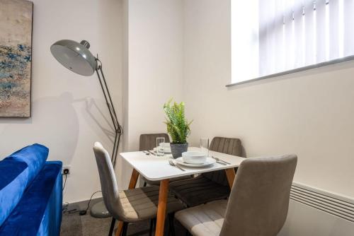 a small dining room with a table and chairs at Smart 2 Bed Budget Apartment in Central Doncaster in Doncaster
