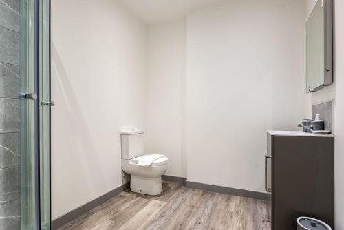 a bathroom with a toilet and a glass shower at Smart 2 Bed Budget Apartment in Central Doncaster in Doncaster
