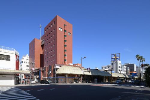 an empty street in a city with a tall building at HOTEL MYSTAYS Miyazaki in Miyazaki