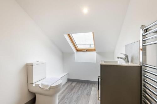 a bathroom with a toilet and a sink at Smart Budget Studio Apartment in Central Doncaster in Doncaster